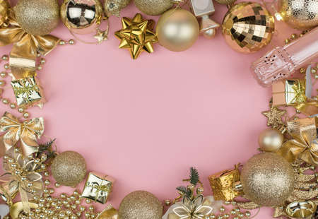 lots of Golden Christmas balls on pink background, New Year background bokeh.の写真素材