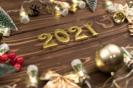 new year 2021 Golden numbers on wooden background with new year decor, Happy Christmas background.の写真素材