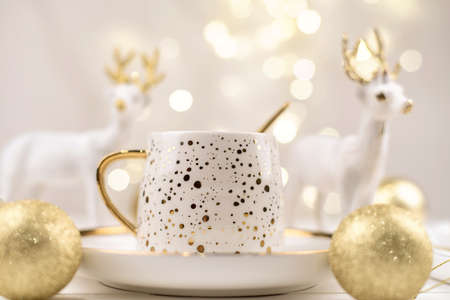Beautiful composition with white Cup with the gold new year's drink.の写真素材