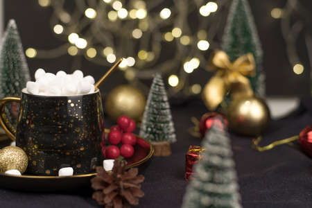 decorative Christmas trees decorated and gifts for the new year on the background of Golden bokeh lights, new year background, new year mood 2021.の写真素材