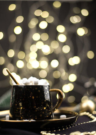 Hot chocolate cocoa with marshmallows on a black Christmas background with Golden bokehの写真素材