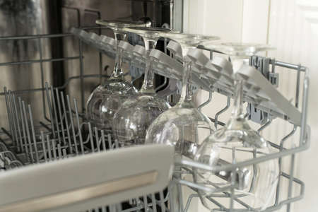 glasses of wine are stacked rhythmically in the dishwasherの写真素材