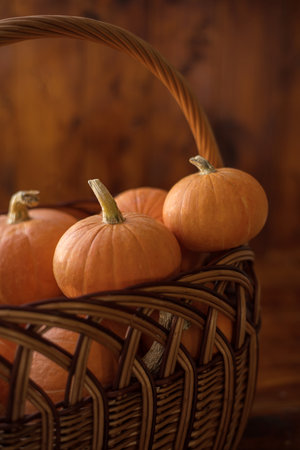 Autumn small orange pumpkin on a wooden table, the harvest, the symbol of Halloween.の写真素材