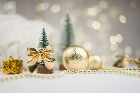 decorative Christmas trees decorated and gifts for the new year on the background of Golden bokeh lights, new year background, new year mood 2021.の写真素材