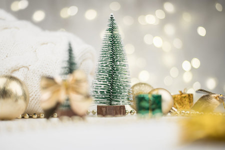decorative Christmas trees decorated and gifts for the new year on the background of Golden bokeh...