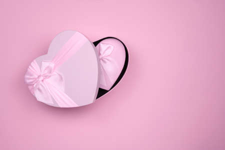 Pink heart-shaped gifts for Valentine's Day with litlle pink box in big, on a pink background.の写真素材