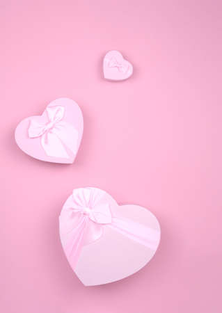 Pink heart-shaped gift with bow for Valentine's Day on a pink background, minimalism.の写真素材