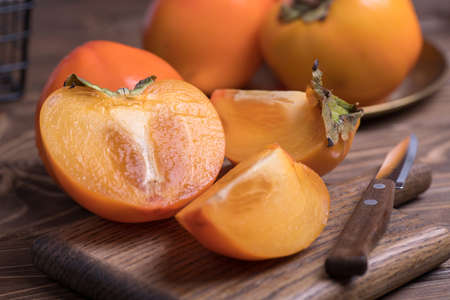 Fresh ripe, orange under persimmons cut into slices, close-up.の写真素材