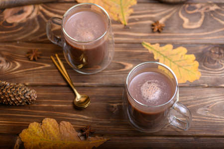 Cocoatwo cups of cocoa on a wooden background.の写真素材