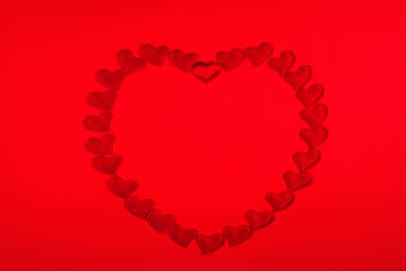 Red hearts in the shape of a heart background for Valentine's Day.の写真素材