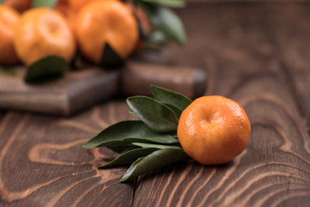 The spin of the tangerine close-up on brown wooden background. Ripe fruitの写真素材