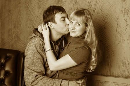 picture of couple in love. a man kissing a woman on the cheekの写真素材