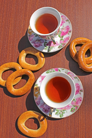 top view. cup of tea standing on a wooden table and lie bagelsの写真素材