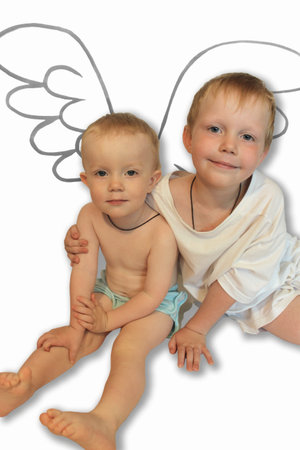 photograph of two brothers children with angel wings on a white backgroundの写真素材