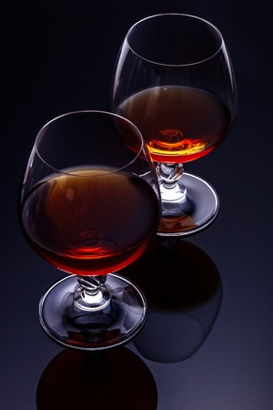 Two glasses of brandy on a dark backgroundの写真素材
