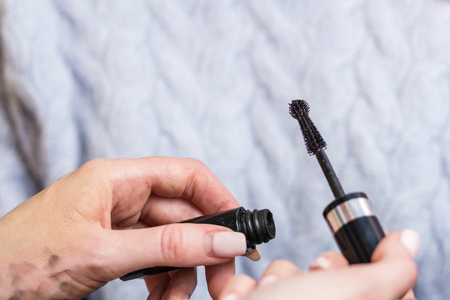 Tuba mascara and eyelash makeup brush in the hands of the make-up artistの写真素材