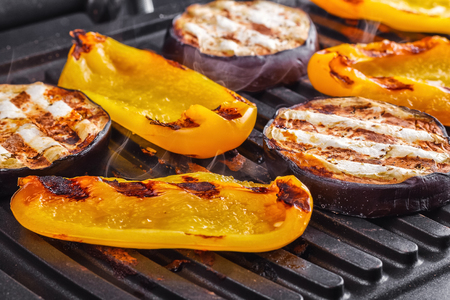 Vegetables: aubergines and yellow pepper on an electric grill. Close-up. Healthy Eatingの写真素材
