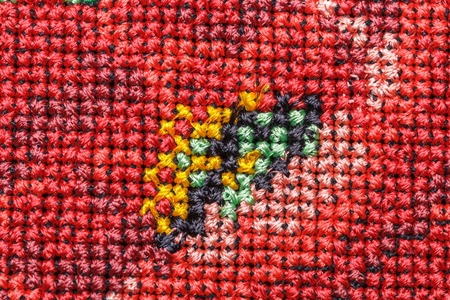 Embroidery, cross-stitch, rice Ukrainian national embroidery, embroidered flowers on a black background, texture, flowers close-upの写真素材