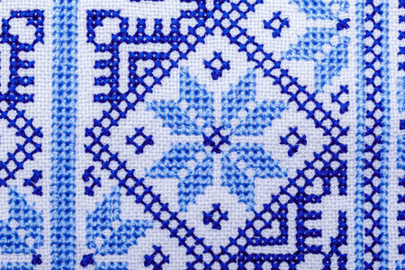 Traditional Ukrainian ornament embroidered with a cross on a linen cloth close-up