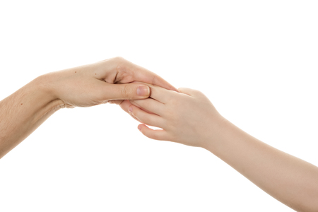 Female hand holding a childs palm isolated on white background. Copy spaceの写真素材