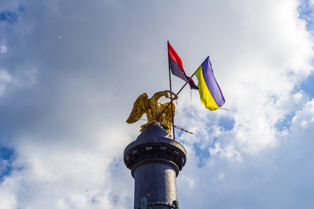 POLTAVA, UKRAINE - May 15, 2018: Monument of Glory with the fixed State Flag of Ukraine and the flag of the Organization of Ukrainian Nationalistsのeditorial素材
