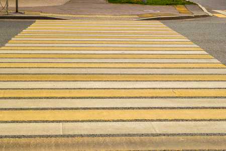 Pedestrian crossing the road - zebra - from the white and yellow stripes in the cityの写真素材