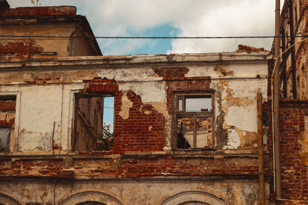 Ruins of a brick building, with remnants of plaster, window frames and ceilings. Reconstruction