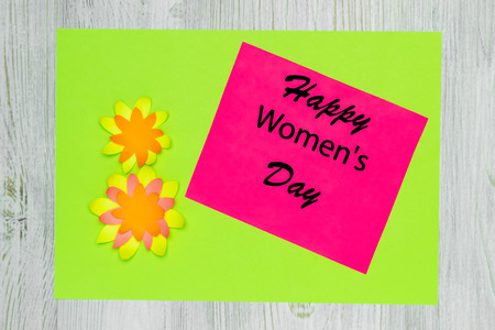 Handmade greeting card made of colored paper and wish Happy Women's Day. Flat lay.の写真素材