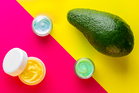 Avocado cream in pot with fruit. Cosmetics from natural ingredients natural concept.の写真素材