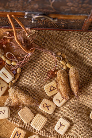 Handmade scandinavian wooden runes on a wooden vintage background. Concept of fortune telling and...