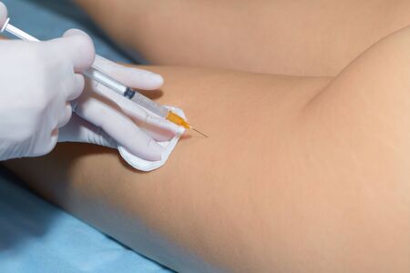 Beautician makes the patient anti-cellulite injection. Close-up. Body care concept.の写真素材