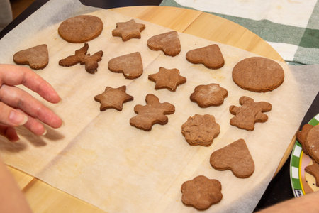 Baking holiday cookies. Woman's hands lay ready-made baking for decoration. Christmas and New Year.