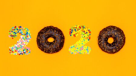 Food concept 2020 made of donuts and confectionery sprinkles. Banner.の写真素材