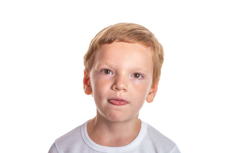 Speech therapy concept. Little boy doing exercises for correct pronunciation. Isolation on a white background. High quality photoの写真素材