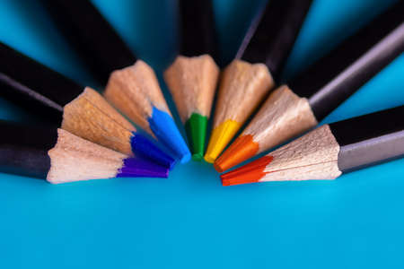 Creative minimal banner. Black wooden colored pencil set arranged in semicircle on blue background. Copy space. Stationery Backdrop. Selective focus. High quality photoの写真素材