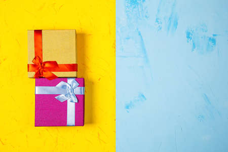 Colored square gift boxes on concrete background, flat lay, top viewの写真素材