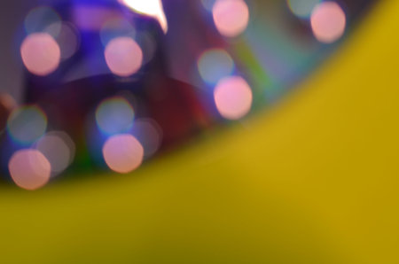 Natural abstract colorful bokeh background received from the light of lamp on CD disk with glitter,...