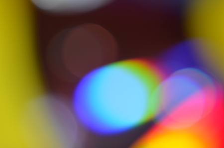 Natural abstract colorful bokeh background received from the light of lamp on CD disk with glitter, defocusedの写真素材