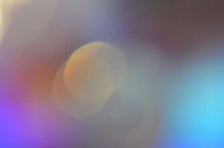 Natural abstract colorful bokeh background received from the light of lamp on CD disk with glitter, defocusedの写真素材