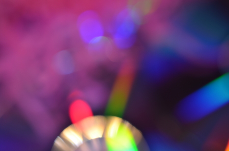 Natural abstract colorful bokeh background received from the light of lamp on CD disk with glitter, defocusedの写真素材