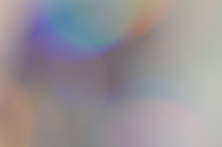 Natural abstract colorful bokeh background received from the light of lamp on CD disk with glitter, defocusedの写真素材