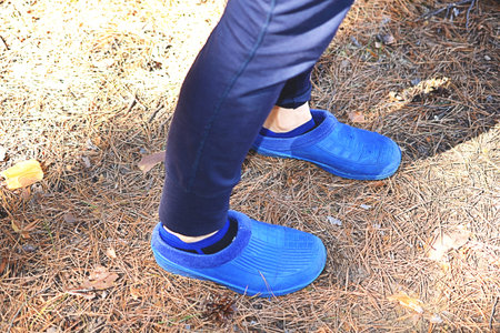 rubber slippers on woman legs. Pair of flip flops, toned