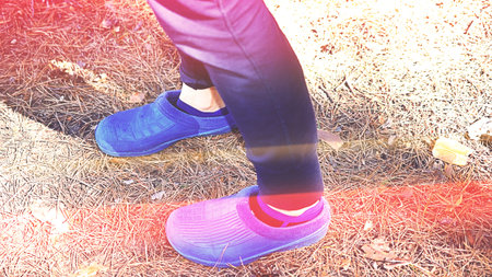 rubber slippers on woman legs. Pair of flip flops, toned