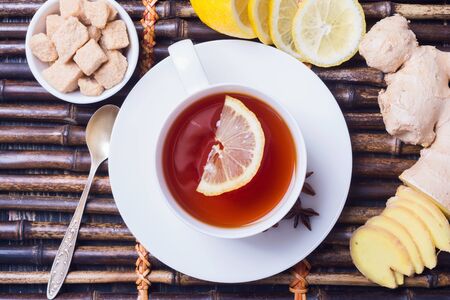 Ginger tea with lemon in a white cup