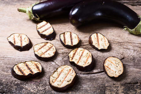 grilled eggplants seasoned on a wooden backgroundの写真素材