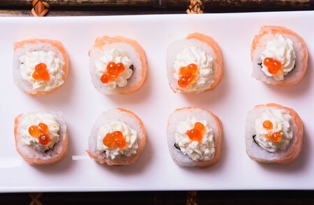 Traditional fresh japanese sushi rolls on black boardの写真素材