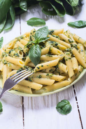 penne pasta with spinach pesto sauce, green basilの写真素材