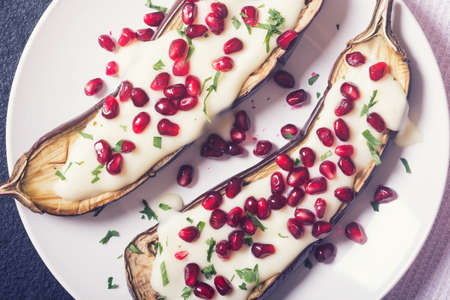 eggplants with garlic yogurt sauce and pomegranateの写真素材