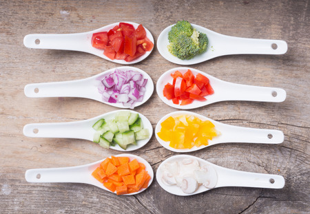 Sliced of vegetables ( pepper , tomato , mushrooms, broccoli, carrots , cucumber , onions )の写真素材