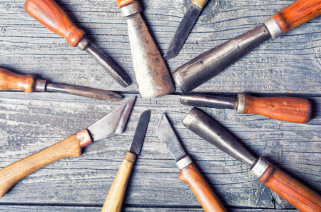 Set of handmade old knife on wooden backgroundの写真素材